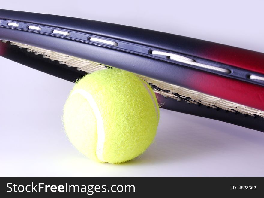 Tennis ball and racquet on white background