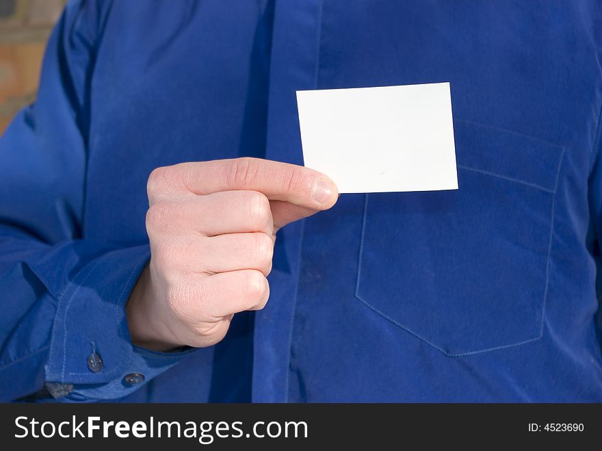 Blank card in hand isolated on blue background