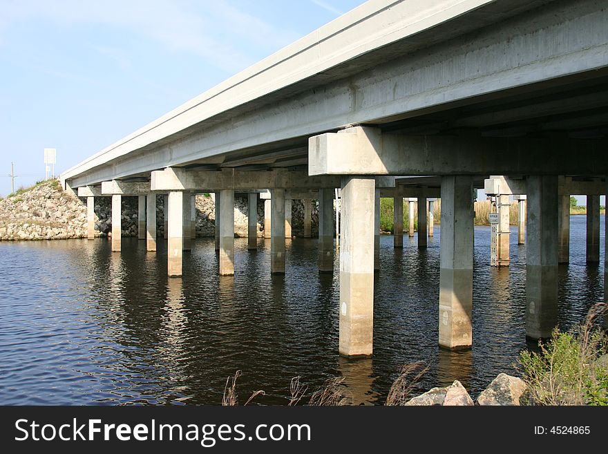 Highway bridge over the Saint John's River, Florida. Shot from below showing support pilings, river and underside of roqdway