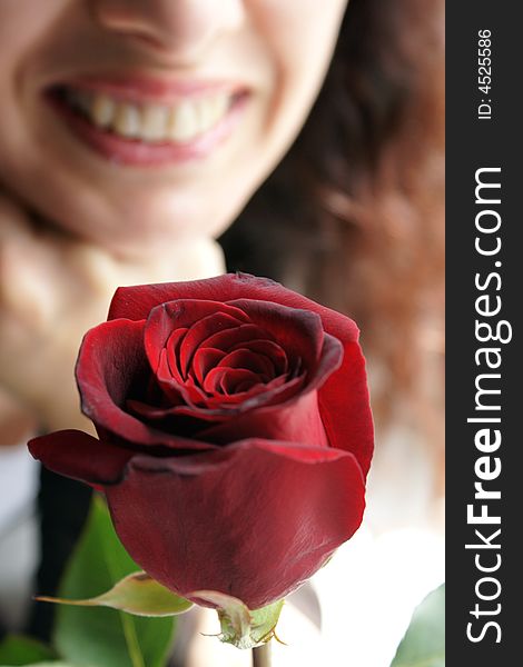 Smiling woman accepting a rose. Smiling woman accepting a rose