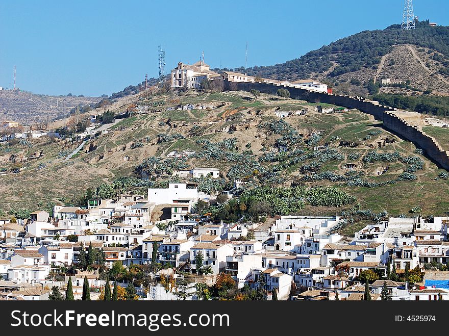 Cave dwellings occupy the hillside as the poor live in these shanties above this neighborhood in Granada, Spain. Cave dwellings occupy the hillside as the poor live in these shanties above this neighborhood in Granada, Spain.