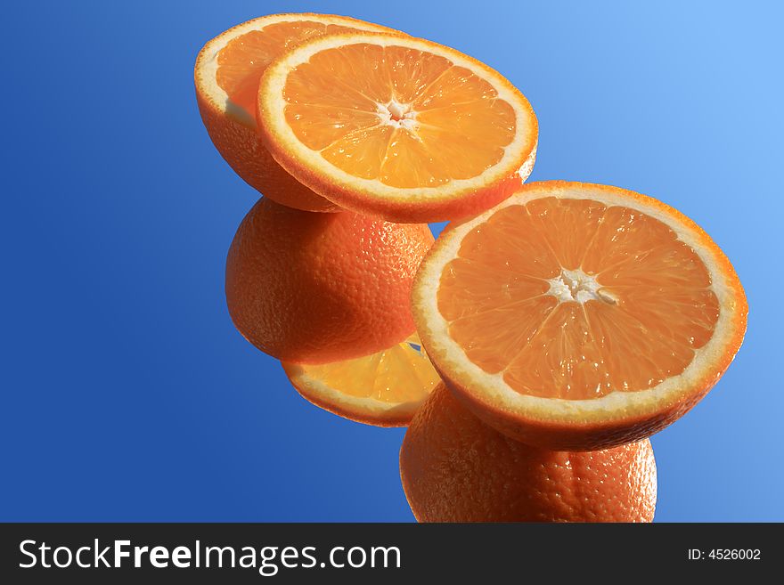 Incised nice orange with reverberation in sunlight on blue background. Incised nice orange with reverberation in sunlight on blue background