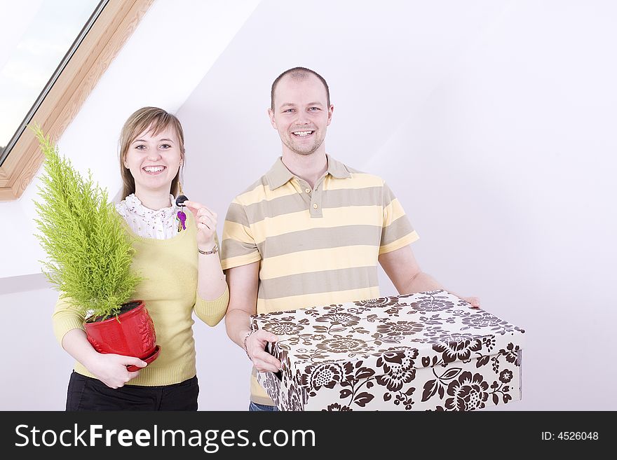 Portrait of young smiling couple in their new home.