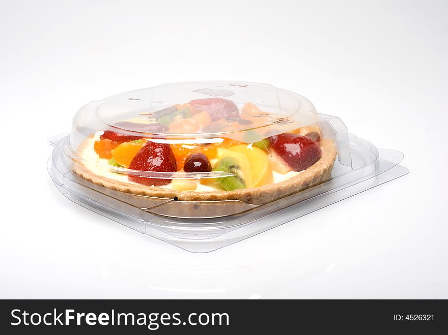 A fruit pie in a closed plastic transparent box
