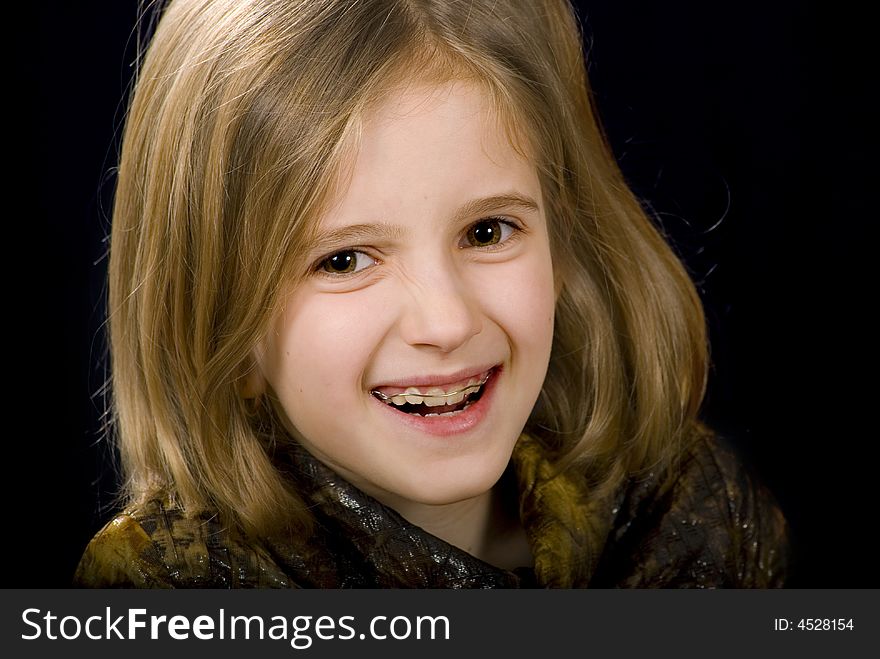 Face of  girl  laughs on the black background. Face of  girl  laughs on the black background