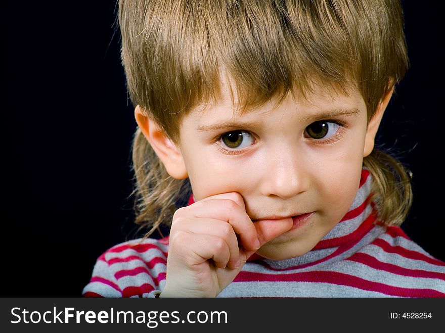 Portrait thinking boy on the black background