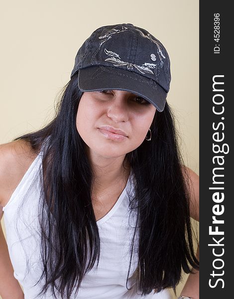 Black hair young woman in cap portrait. studio shot.