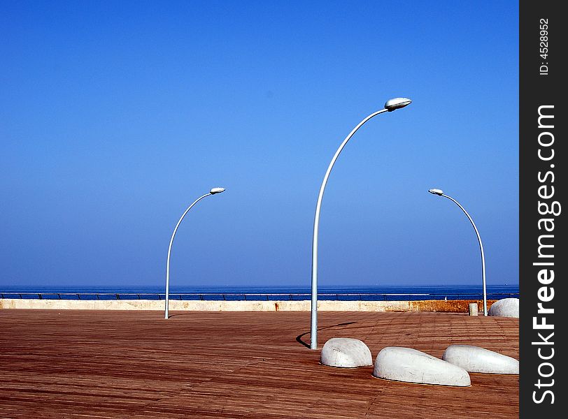Shore of sea and three lanterns and blue sky