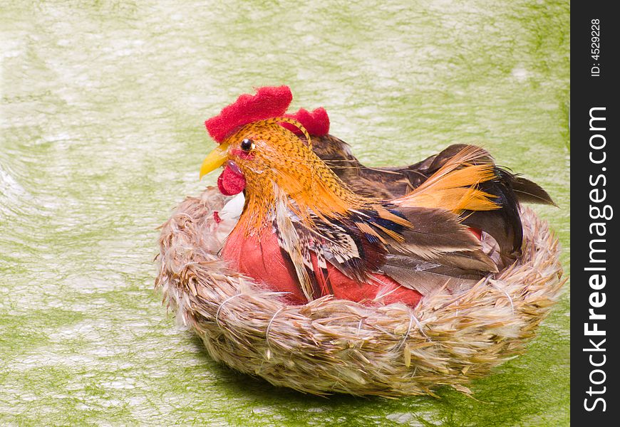 Cock and hen siiting in nest on green background. It's popular Eastern motif.