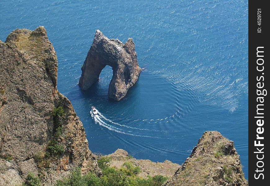 Walk on a boat near a rock  Golden Gate , Crimea, Кaradag