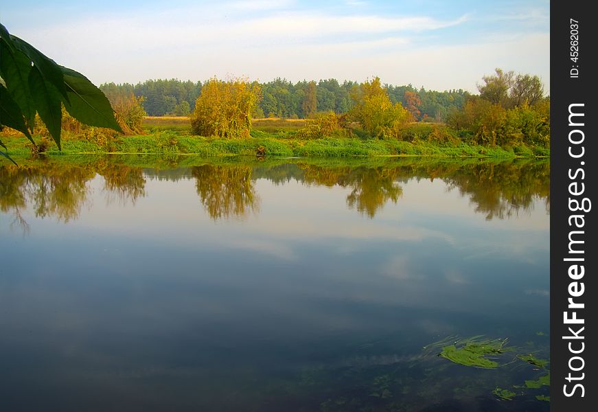 Calm river in autumn forest in the morning time. Calm river in autumn forest in the morning time.