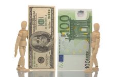 Manikins Hold Euro And Dollar Bills Royalty Free Stock Photography