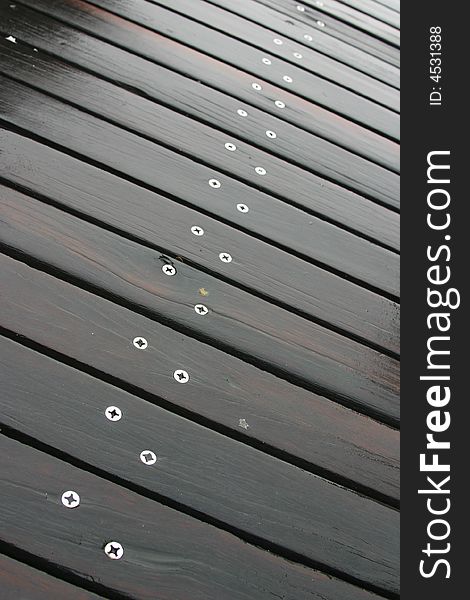 Vertical abstract image of a boardwalk in the rain