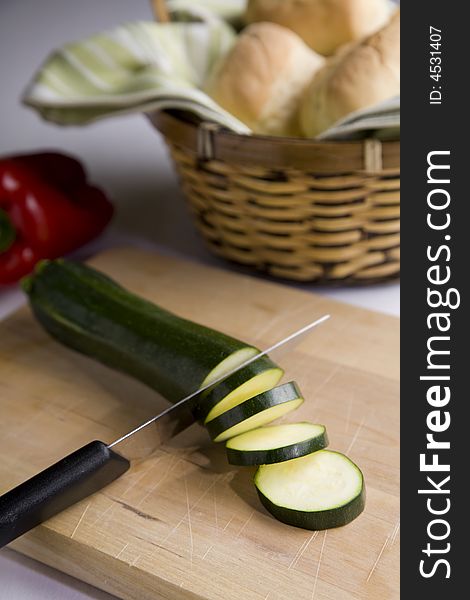 Vertical image of knife slicing vegetables. Vertical image of knife slicing vegetables