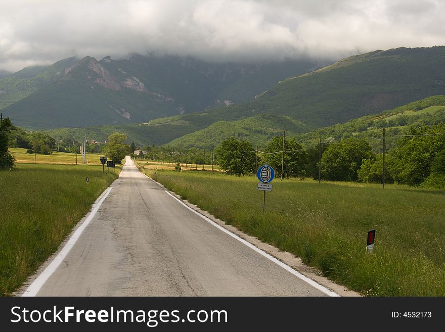 A road leads into the mountains of the central Apennines in Le Marche, central Italy. A road leads into the mountains of the central Apennines in Le Marche, central Italy