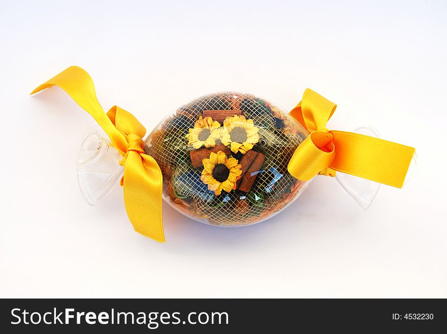 A glass sweet filled with flowers and yellow narrow