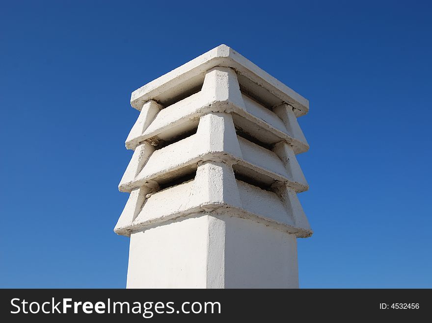 A cement funnel with sky as background. A cement funnel with sky as background