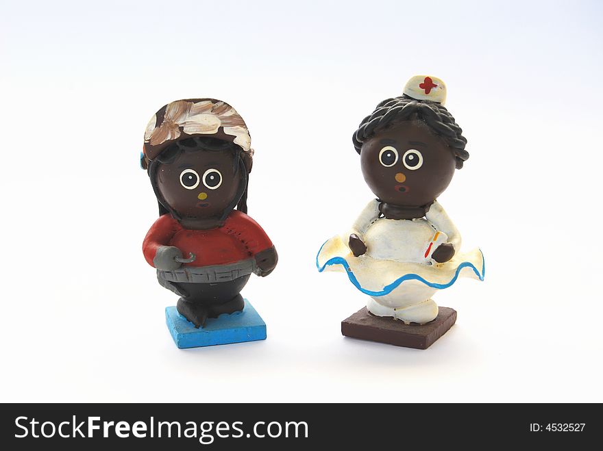 Two black clay dolls: a nurse and a hook man. Two black clay dolls: a nurse and a hook man