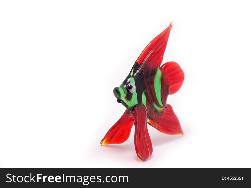 Little red and green color glass fish on white background. Little red and green color glass fish on white background