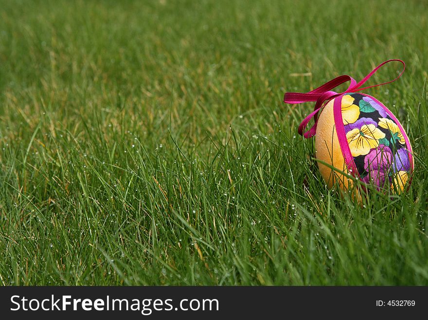 Hand crafted colorful easter eggs in a green meadow. Hand crafted colorful easter eggs in a green meadow
