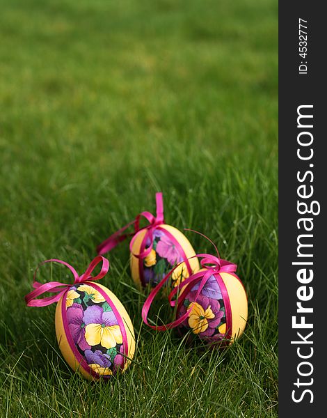 Hand crafted colorful easter eggs in a green meadow. Hand crafted colorful easter eggs in a green meadow