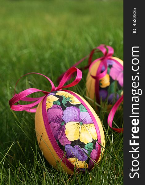 Hand crafted colorful easter eggs in a green meadow. Hand crafted colorful easter eggs in a green meadow