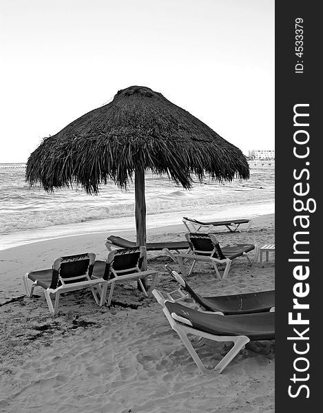 Umbrella, beach, chairs ocean  in black and white. Umbrella, beach, chairs ocean  in black and white