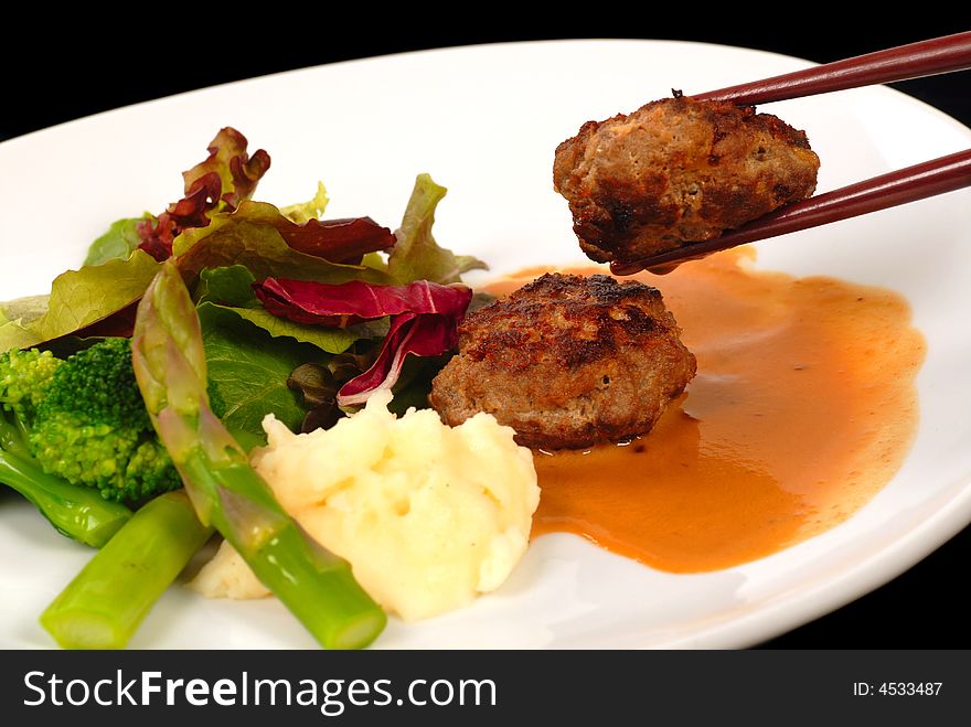 Delicious Asian Kobe beef meatballs with mashed potatoes and salad. Delicious Asian Kobe beef meatballs with mashed potatoes and salad