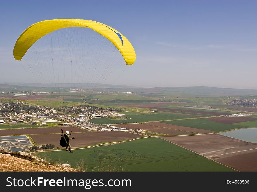 Parachutist just run from a cliff for gliding with a free fall parachute.