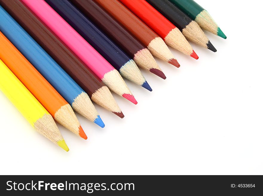 Several colored pencils over a white surface