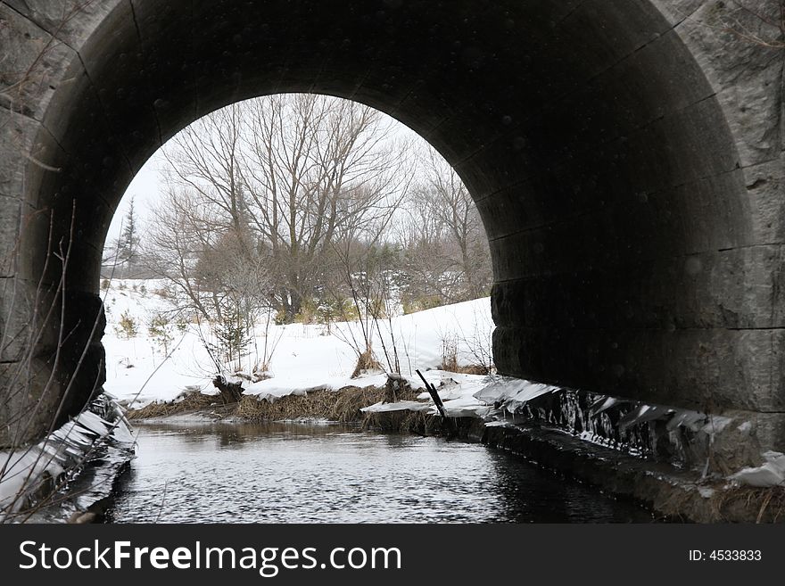 Through Bridge. A nice picture lloking through a tunnel to view the scenery in the background. The Tunnel acts as of frame for the landscape in the background