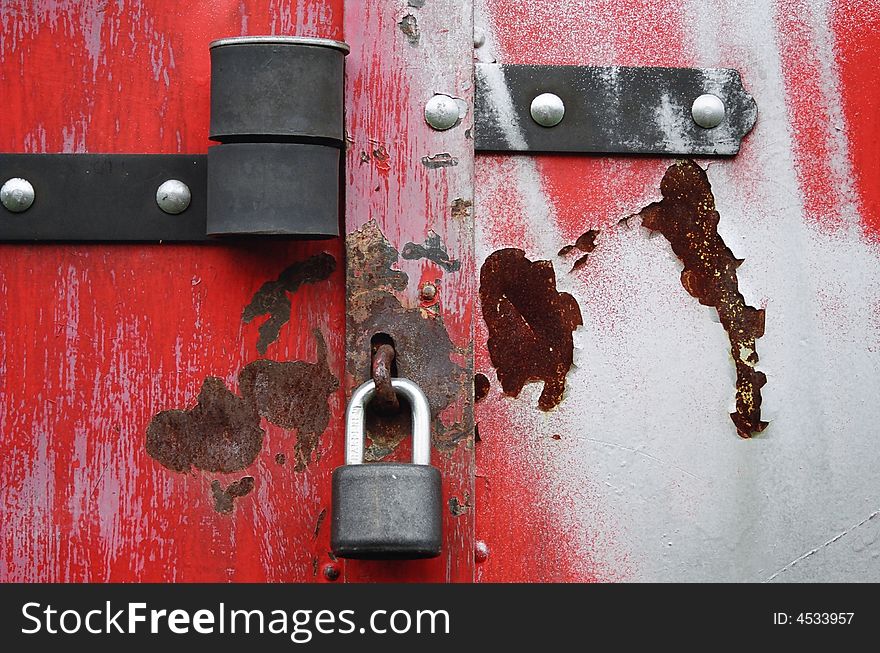 Padlock on a rusty garage gate