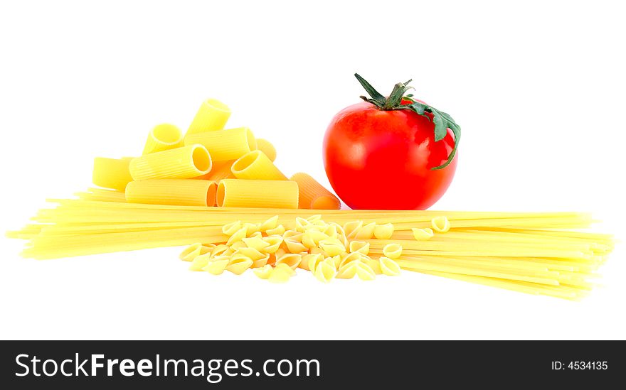 Variety of raw pastas and tomato. Variety of raw pastas and tomato