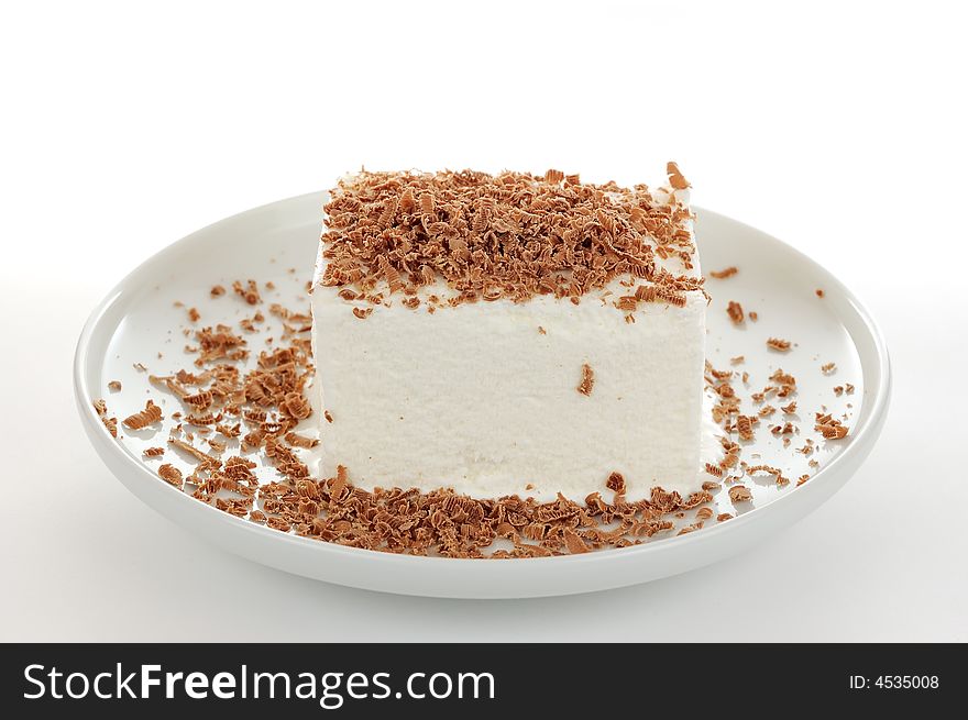 The milk icecream with grated brown chocolate on the white plate