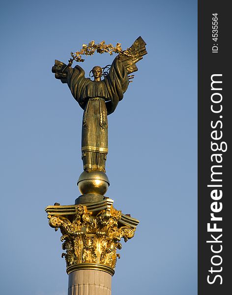 This is a statue of an angel, made of copper, and gold plated, standing on a tall pillar, in the center of Kiev, Ukraine. This is a statue of an angel, made of copper, and gold plated, standing on a tall pillar, in the center of Kiev, Ukraine.