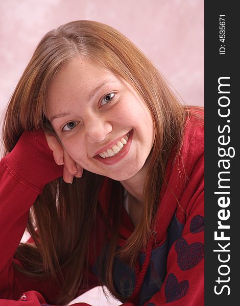 Smiling teenager with a big smile in a red shirt