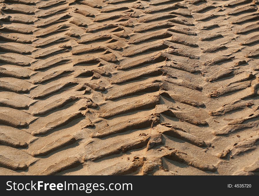 Tyre tracks on sandy ground in the gravel-pit.