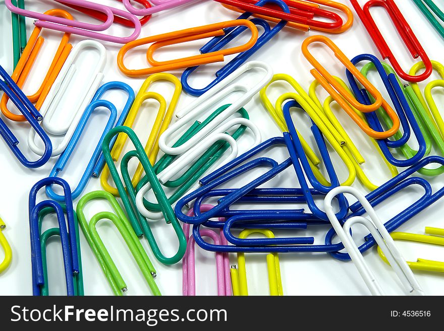 Close view of milti-colored paper clips on white background