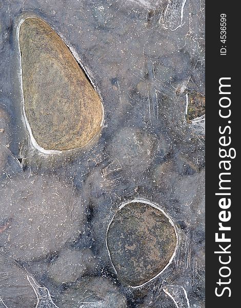 stones in icy waters in a river. stones in icy waters in a river