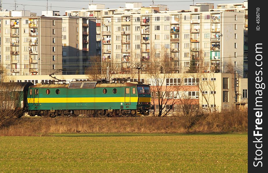 Green electric locomotive with part of carriage
