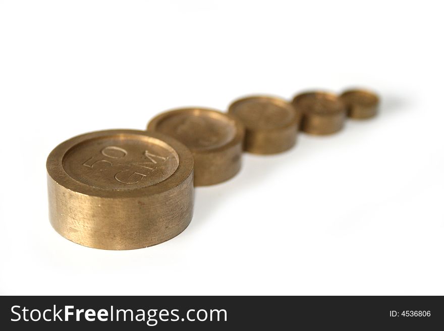 A macro shot of a row of antique weights