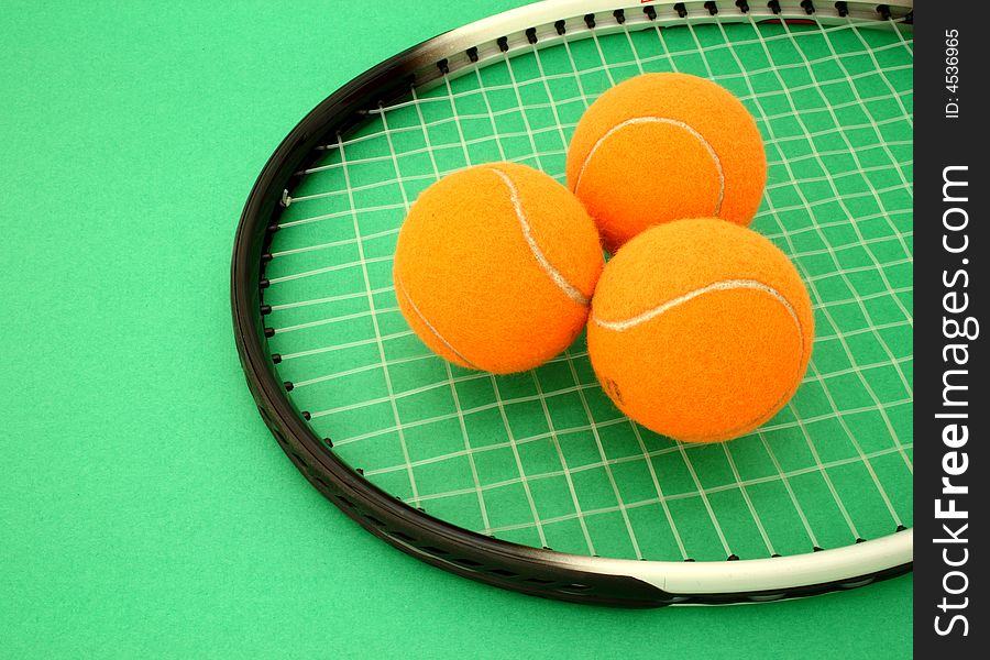 Three tennis balls over a racket