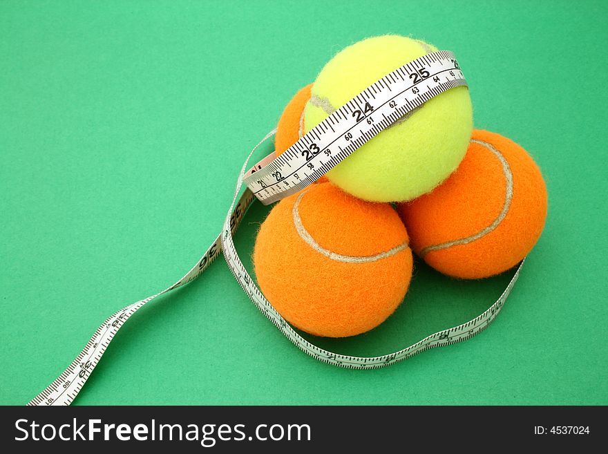 Tape measure wrapped around four tennis balls. Tape measure wrapped around four tennis balls