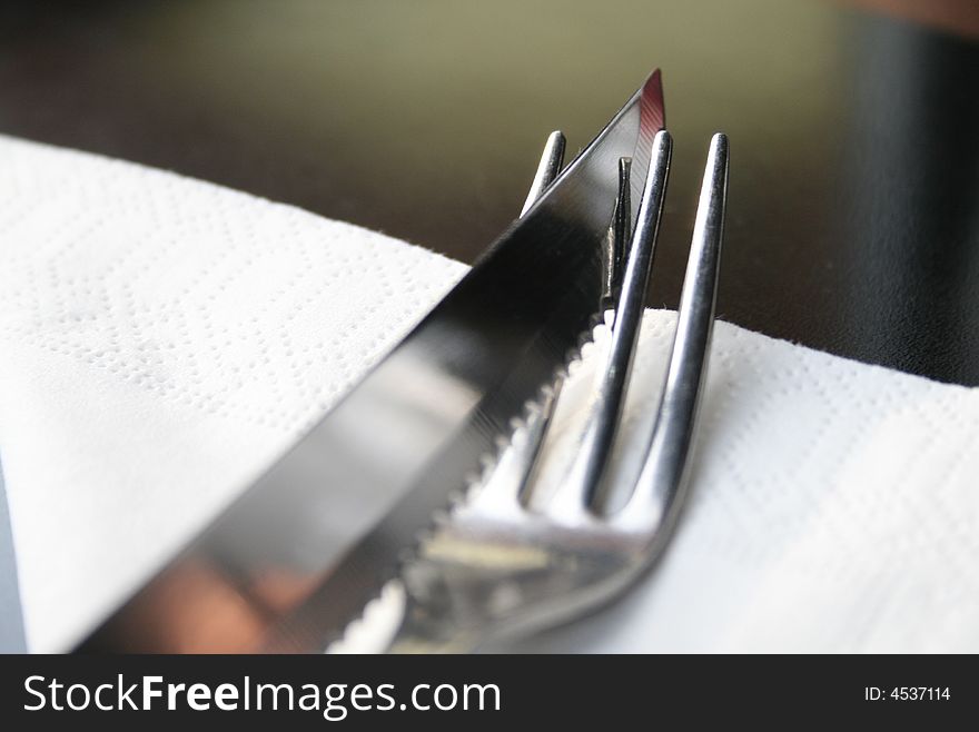 A fork with a knife on the table. A fork with a knife on the table
