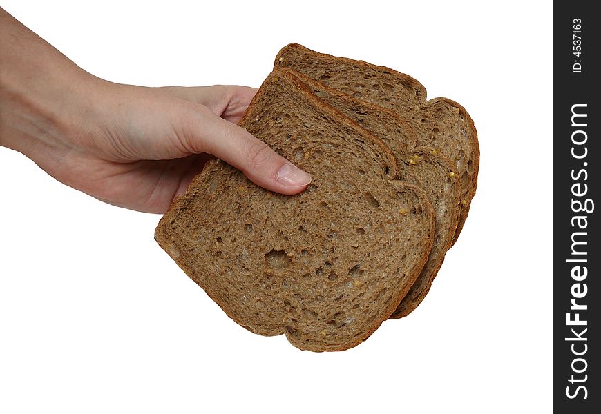 Hand holding three slices of cereal bread
