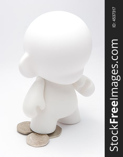 An abstract character standing on coins. An abstract character standing on coins.