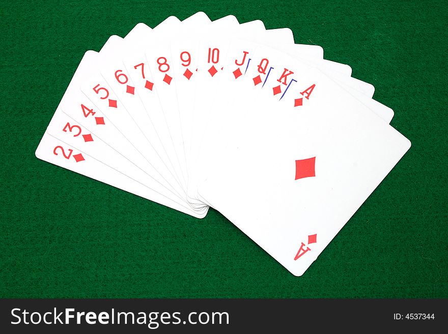 Full set of diamond cards over a green surface