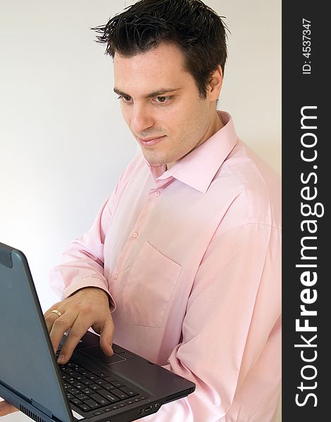 A man, holding a laptop computer, in his hands, smiling. A man, holding a laptop computer, in his hands, smiling