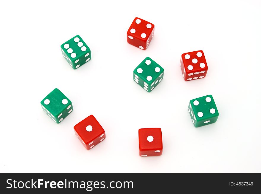 Several red and green dice over a white surface