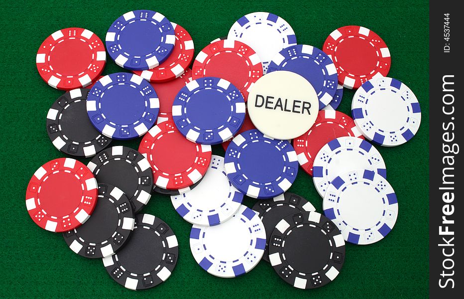 Colorful gambling chips over a green table. Colorful gambling chips over a green table